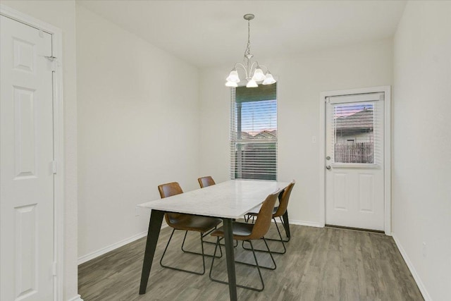 201 Cascata Way, Liberty Hill, TX 78642 - dining space featuring a chandelier, wood finished floors, and baseboards