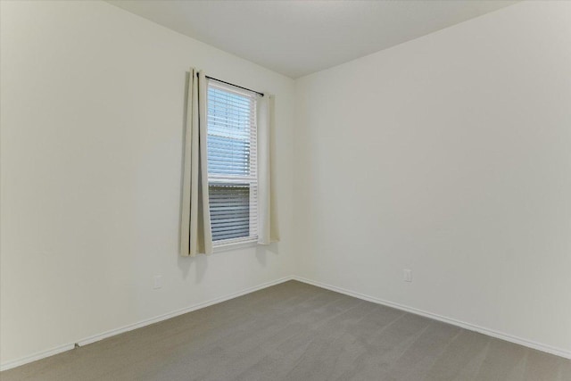 201 Cascata Way, Liberty Hill, TX 78642 - unfurnished room with baseboards and dark carpet