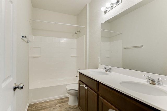 201 Cascata Way, Liberty Hill, TX 78642 - bathroom featuring wood finished floors, toilet, double vanity, and shower / tub combination