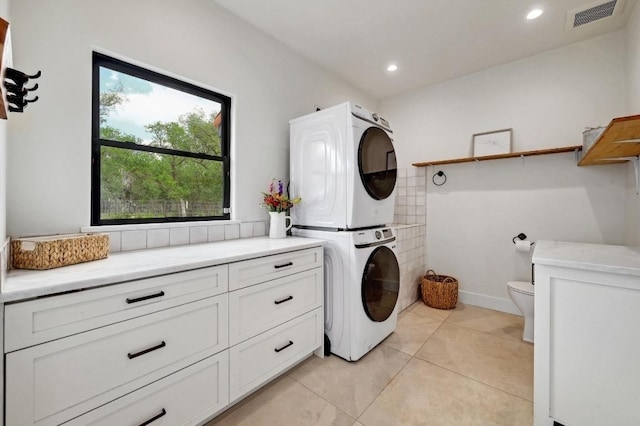 laundry room with laundry area, visible vents, recessed lighting, stacked washer and clothes dryer, and light tile patterned floors