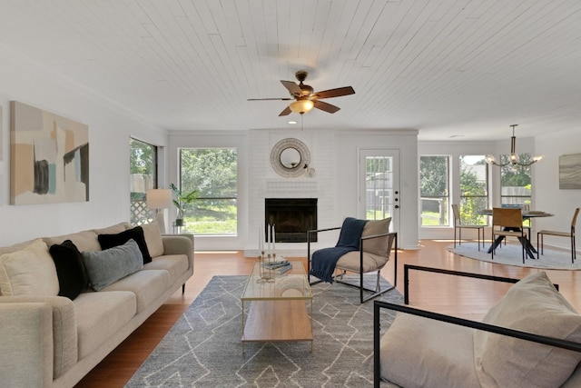 14400 Weldon Ln, Austin, TX 78728 - living room with dark wood-style flooring, ceiling fan, a brick fireplace, a chandelier, and wooden ceiling