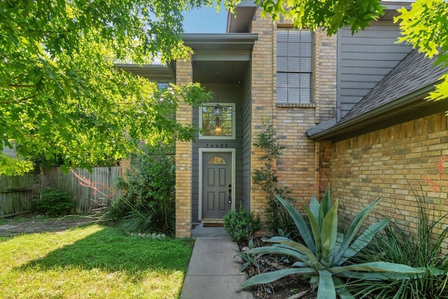 14400 Weldon Ln, Austin, TX 78728 - view of exterior entry featuring brick siding and roof with shingles