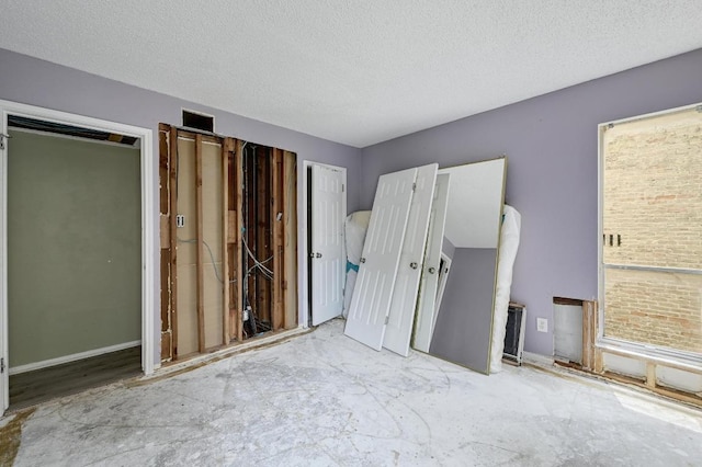 unfurnished bedroom with a textured ceiling