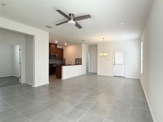 4482 Acerno St, Round Rock, TX 78665 - unfurnished living room with a chandelier, a ceiling fan, light tile patterned floors, and recessed lighting