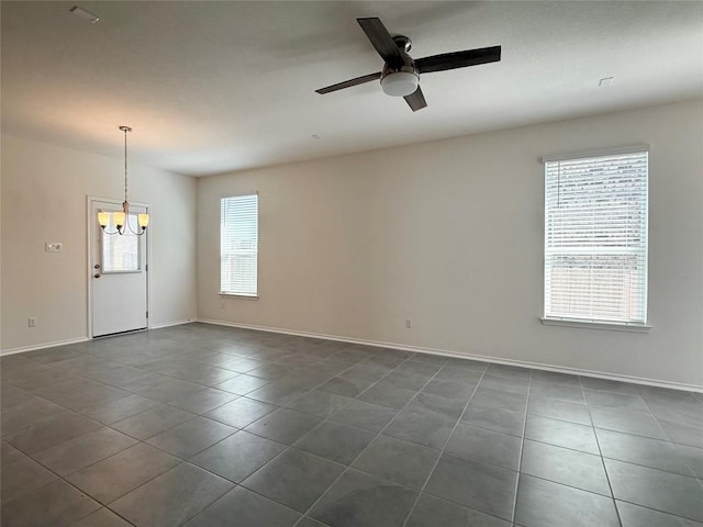 4482 Acerno St, Round Rock, TX 78665 - empty room with a chandelier, dark tile patterned floors, and ceiling fan