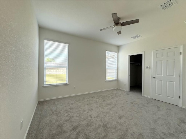 4482 Acerno St, Round Rock, TX 78665 - unfurnished bedroom with carpet flooring, a spacious closet, and a ceiling fan