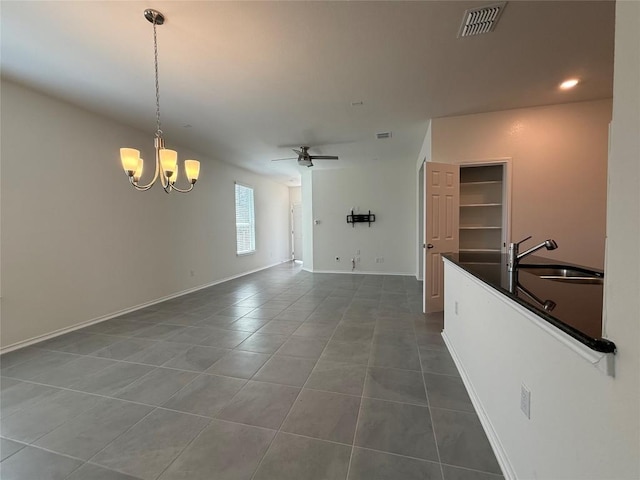 4482 Acerno St, Round Rock, TX 78665 - unfurnished dining area with dark tile patterned floors, a chandelier, ceiling fan, and recessed lighting