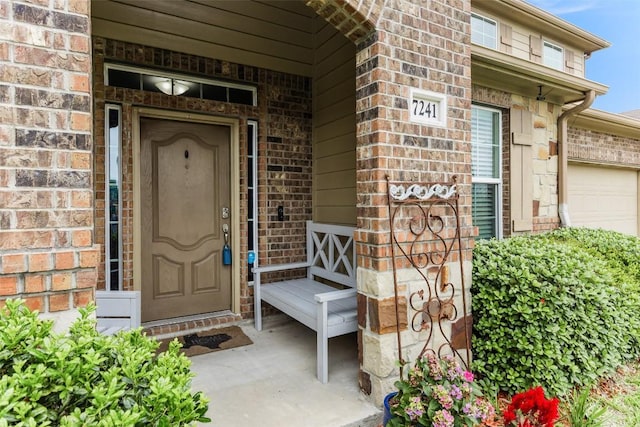 7241 Dunns Point Dr, Corpus Christi, TX 78414 - doorway to property featuring brick siding, a garage, and a porch