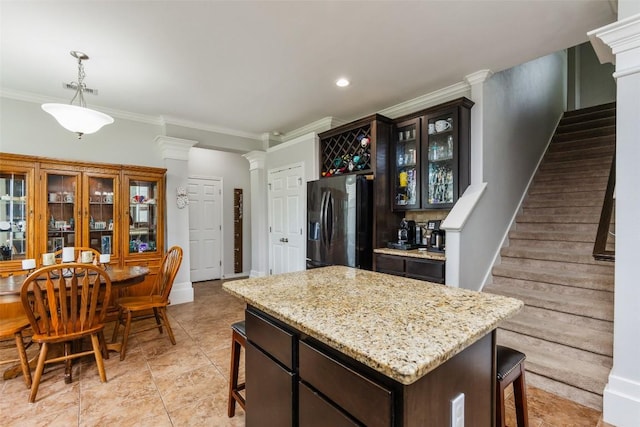 7241 Dunns Point Dr, Corpus Christi, TX 78414 - kitchen with a breakfast bar area, glass insert cabinets, ornate columns, refrigerator with ice dispenser, and ornamental molding