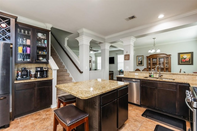 7241 Dunns Point Dr, Corpus Christi, TX 78414 - kitchen featuring light tile patterned flooring, decorative columns, a sink, visible vents, and appliances with stainless steel finishes