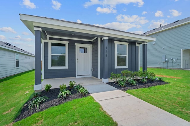 127 Safflower Dr, Uhland, TX 78640 - view of front facade featuring board and batten siding, a porch, and a front lawn