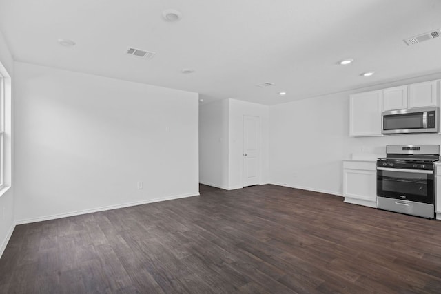 127 Safflower Dr, Uhland, TX 78640 - kitchen with appliances with stainless steel finishes, visible vents, dark wood-style flooring, and baseboards