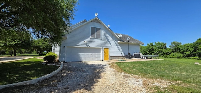 8660 Cedar Hill Rd, Brenham, TX 77833 - view of side of home with dirt driveway, a lawn, and a garage