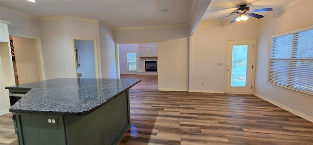 8660 Cedar Hill Rd, Brenham, TX 77833 - kitchen featuring wood finished floors, a ceiling fan, plenty of natural light, ornamental molding, and a center island