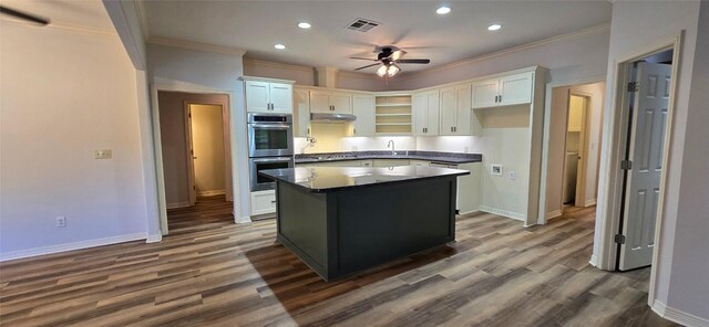 8660 Cedar Hill Rd, Brenham, TX 77833 - kitchen featuring double oven, crown molding, white cabinetry, dark countertops, and recessed lighting