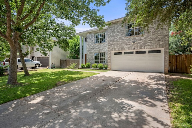 905 Whispering Hollow Dr, Kyle, TX 78640 - view of front of home with fence, a garage, a front lawn, and driveway