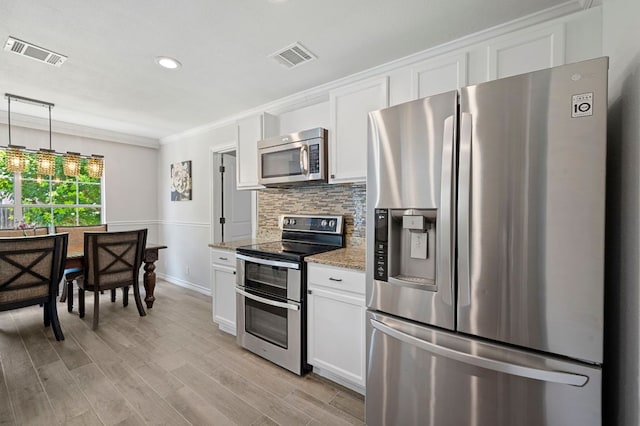 905 Whispering Hollow Dr, Kyle, TX 78640 - kitchen with white cabinetry, stainless steel appliances, tasteful backsplash, and visible vents