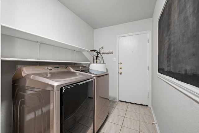 905 Whispering Hollow Dr, Kyle, TX 78640 - laundry room with light tile patterned floors, laundry area, separate washer and dryer, and baseboards