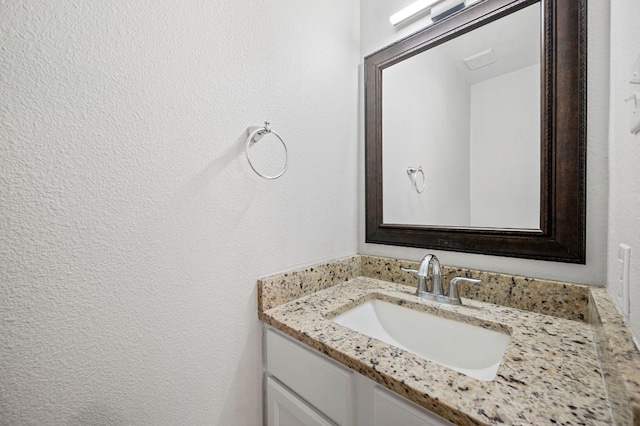 905 Whispering Hollow Dr, Kyle, TX 78640 - bathroom featuring vanity and a textured wall