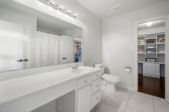 905 Whispering Hollow Dr, Kyle, TX 78640 - full bath featuring toilet, marble finish floor, visible vents, vanity, and a walk in closet