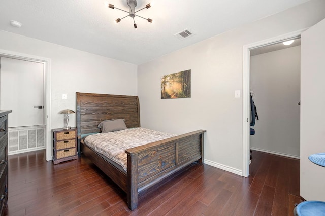 905 Whispering Hollow Dr, Kyle, TX 78640 - bedroom featuring dark wood-type flooring, baseboards, and visible vents