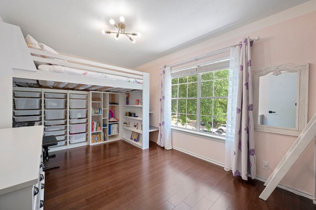 905 Whispering Hollow Dr, Kyle, TX 78640 - bedroom with an inviting chandelier, baseboards, and dark wood-style floors