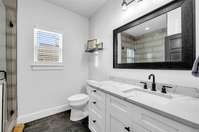 bathroom featuring baseboards, a shower stall, toilet, and vanity