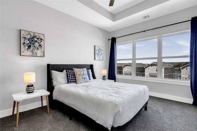 carpeted bedroom with baseboards, visible vents, and a ceiling fan
