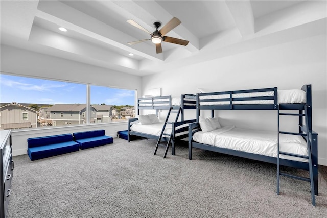 carpeted bedroom with a ceiling fan, beam ceiling, a residential view, and recessed lighting