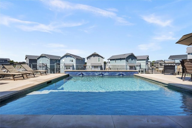 outdoor pool featuring a residential view and a patio