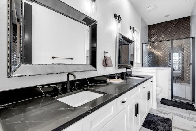 bathroom featuring toilet, marble look tile flooring, double vanity, and a shower stall
