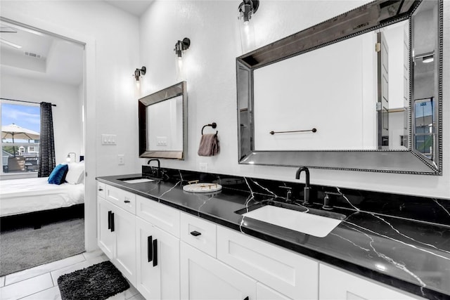 ensuite bathroom featuring ensuite bath, visible vents, a sink, and double vanity