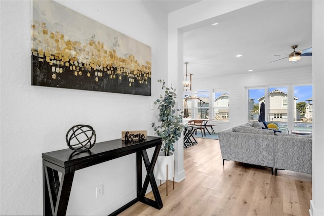 hallway featuring a chandelier, recessed lighting, and wood finished floors