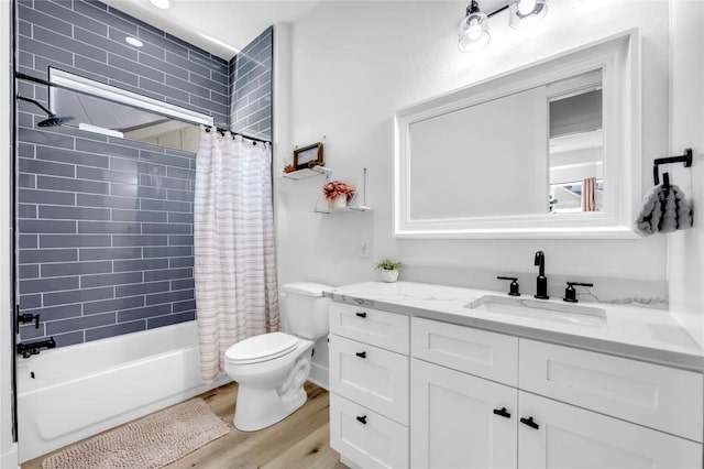 full bathroom featuring toilet, shower / bathtub combination with curtain, vanity, and wood finished floors