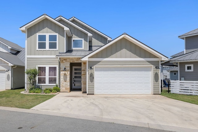 craftsman inspired home with board and batten siding, fence, a garage, and driveway