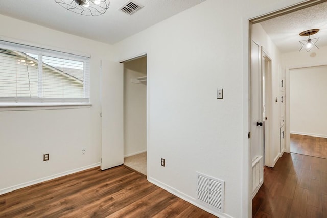 302 Garden Ct, Round Rock, TX 78664 - unfurnished bedroom with baseboards, visible vents, and wood finished floors