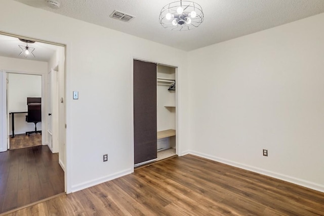 302 Garden Ct, Round Rock, TX 78664 - unfurnished bedroom with baseboards, visible vents, and wood finished floors