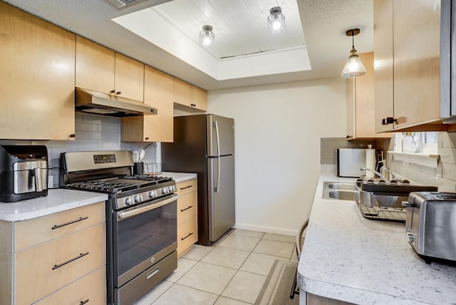302 Garden Ct, Round Rock, TX 78664 - kitchen with a tray ceiling, stainless steel appliances, light brown cabinets, under cabinet range hood, and decorative backsplash