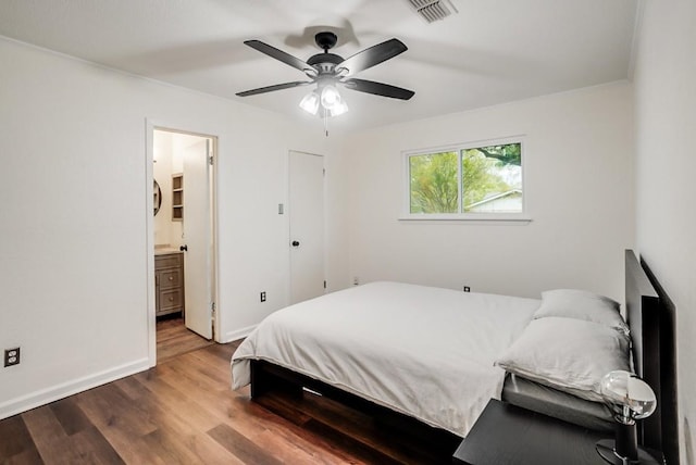 302 Garden Ct, Round Rock, TX 78664 - bedroom with a ceiling fan, baseboards, visible vents, connected bathroom, and wood finished floors