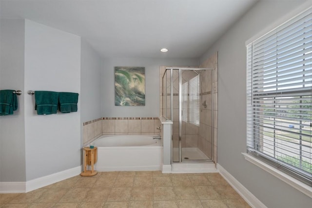 bathroom featuring a stall shower, a garden tub, baseboards, and recessed lighting