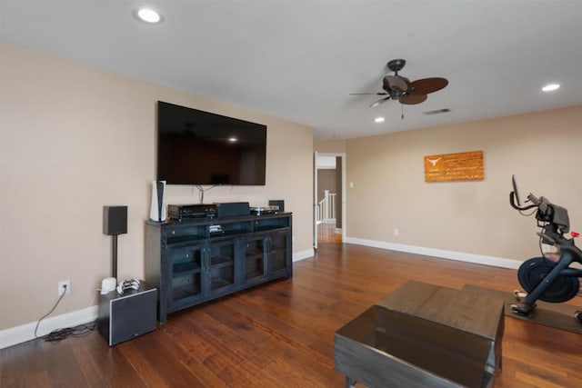 exercise area featuring baseboards, ceiling fan, and wood finished floors