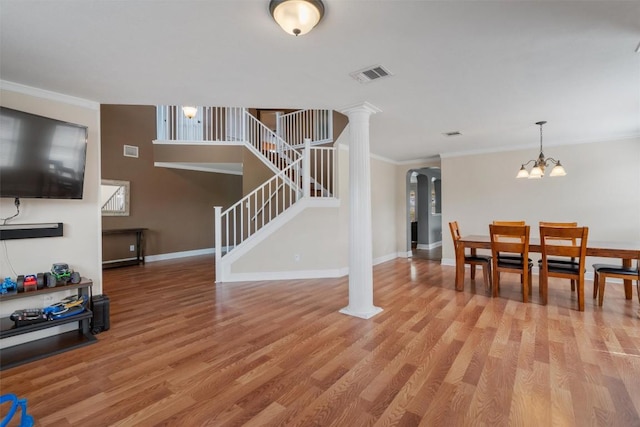 interior space featuring stairway, crown molding, light wood-style flooring, and visible vents