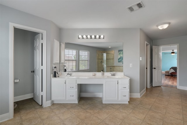 ensuite bathroom featuring a sink, visible vents, a stall shower, ceiling fan, and double vanity