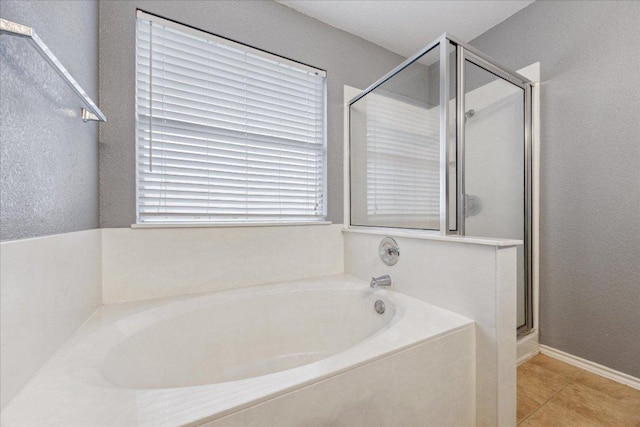 full bathroom featuring a garden tub, tile patterned flooring, and a stall shower
