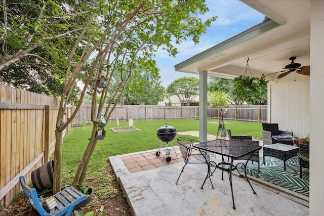 view of patio featuring outdoor dining space, ceiling fan, and a fenced backyard