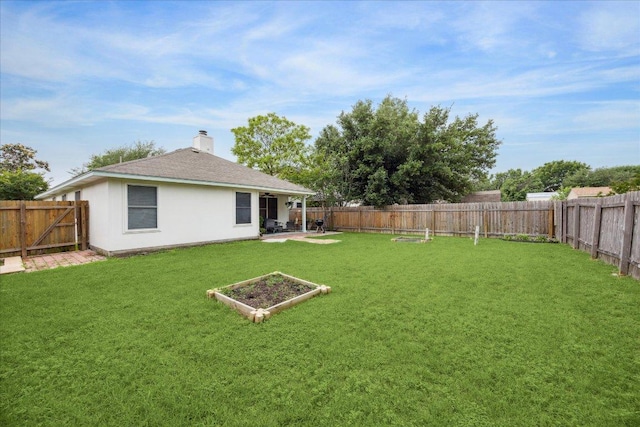 view of yard featuring a patio area and a fenced backyard