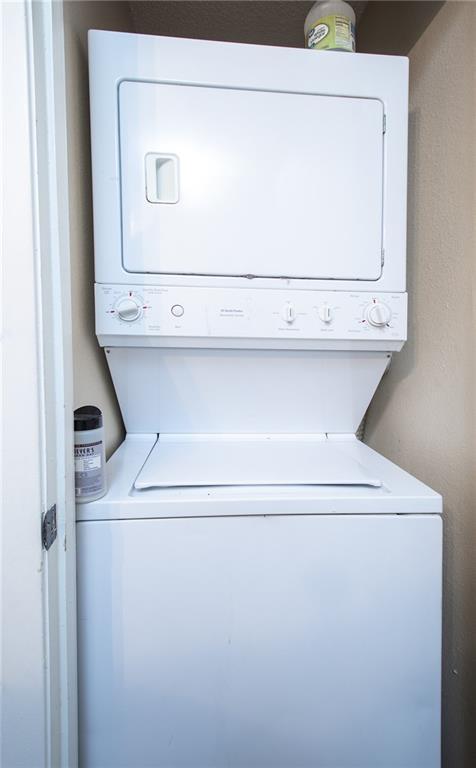 clothes washing area featuring laundry area and stacked washer and dryer
