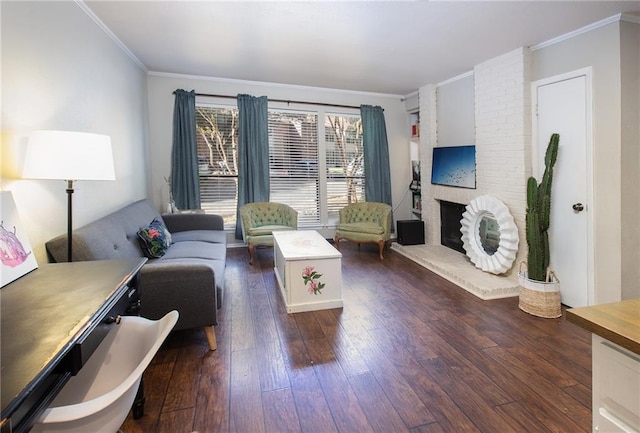 living area featuring dark wood-style flooring, ornamental molding, and a brick fireplace
