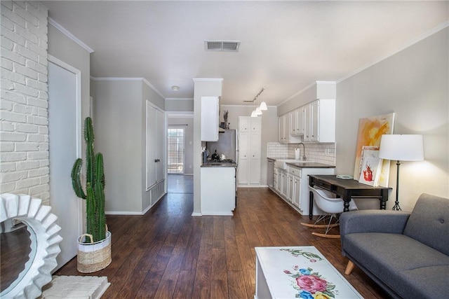 kitchen with visible vents, open floor plan, decorative backsplash, white cabinets, and dark wood-style floors