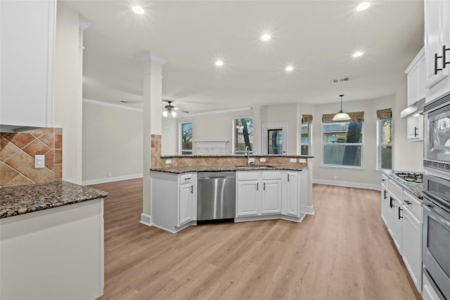 2509 Salorn Way, Round Rock, TX 78681 - kitchen with white cabinetry, stainless steel appliances, a sink, and backsplash
